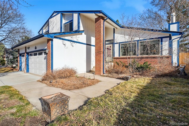 view of front of home with brick siding, a chimney, concrete driveway, and a garage