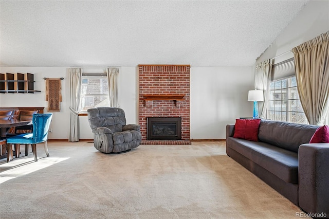 carpeted living area featuring plenty of natural light, a fireplace, a textured ceiling, and baseboards