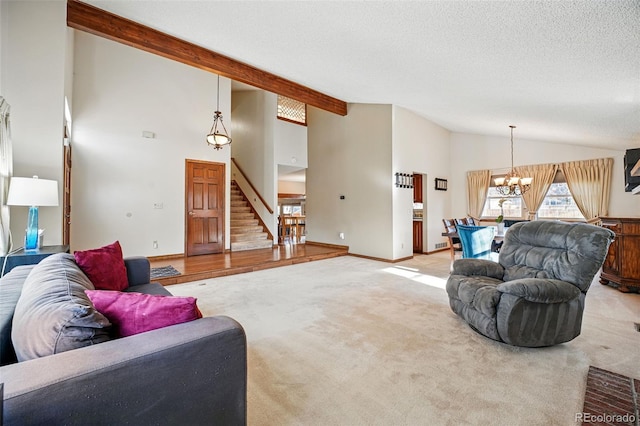 living room with stairs, an inviting chandelier, a textured ceiling, and light carpet