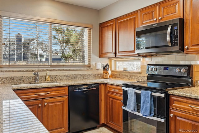 kitchen featuring stainless steel microwave, backsplash, dishwasher, range with two ovens, and a sink