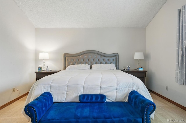 carpeted bedroom with baseboards and a textured ceiling