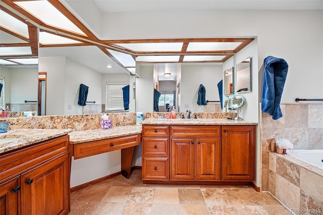 bathroom featuring a bath, vanity, and stone finish floor