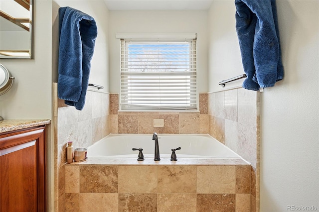 bathroom with vanity and a garden tub