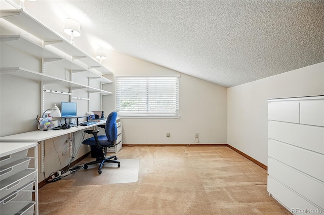 office space with vaulted ceiling, light colored carpet, baseboards, and a textured ceiling