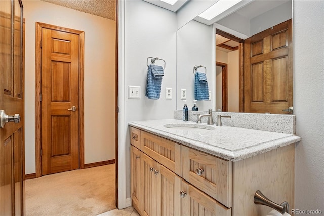 bathroom with vanity and baseboards