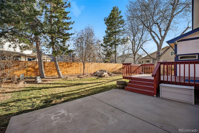 view of patio with a deck and fence