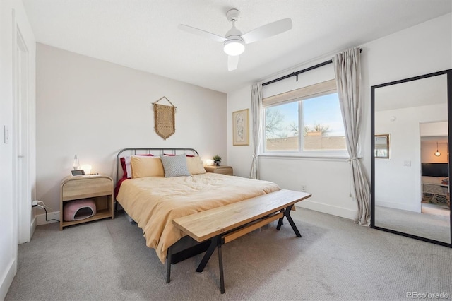 carpeted bedroom featuring baseboards and a ceiling fan