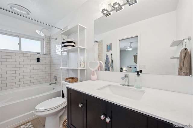 bathroom with ceiling fan, wood finished floors, vanity, toilet, and  shower combination