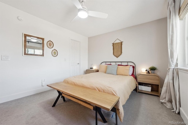 carpeted bedroom featuring baseboards and ceiling fan