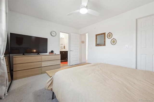 bedroom with ensuite bathroom and a ceiling fan