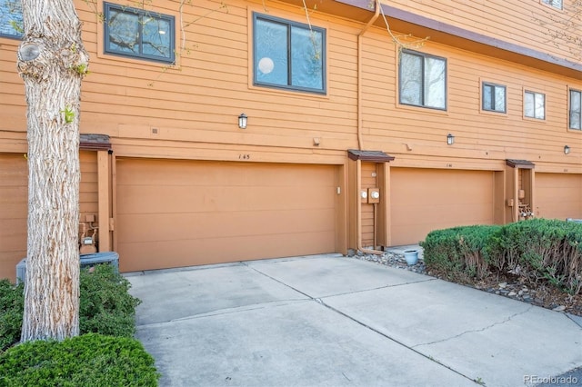 exterior space with an attached garage and concrete driveway