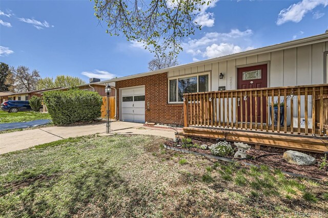 ranch-style home with board and batten siding, an attached garage, and concrete driveway