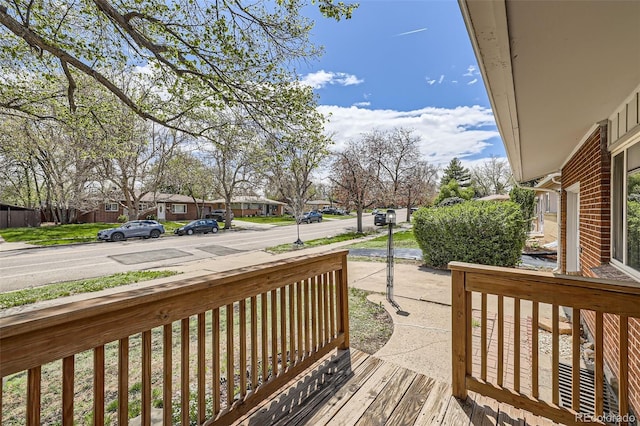 deck with covered porch and a residential view