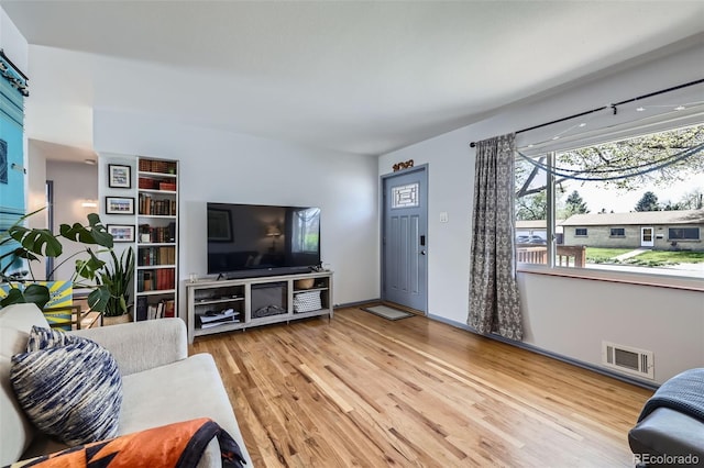 living room with wood finished floors and visible vents