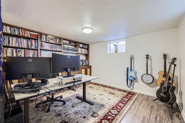 home office featuring baseboards and wood finished floors