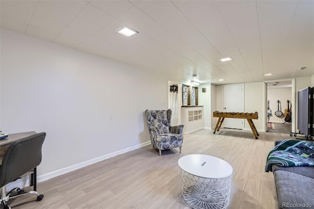 interior space featuring baseboards and light wood finished floors