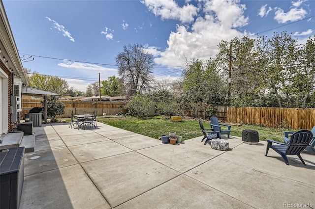view of patio with cooling unit, a fenced backyard, and outdoor dining space