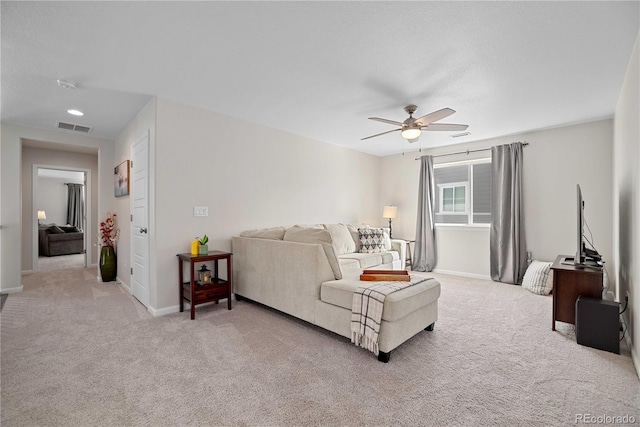 carpeted living room featuring ceiling fan