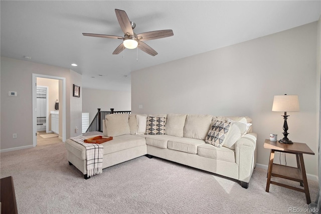 carpeted living room featuring ceiling fan