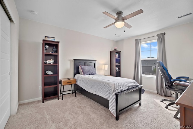 bedroom with ceiling fan, a closet, and light colored carpet