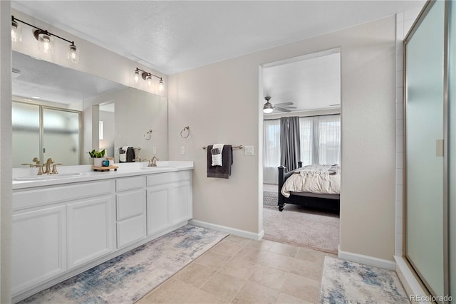 bathroom with tile patterned floors, an enclosed shower, a textured ceiling, vanity, and ceiling fan