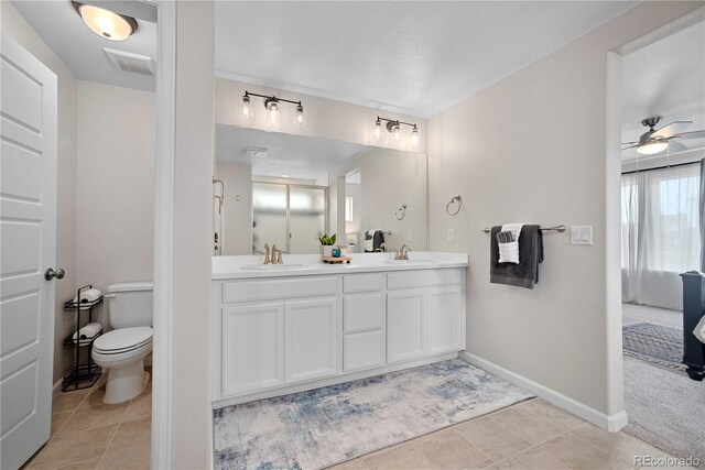 bathroom with tile patterned floors, ceiling fan, vanity, and toilet