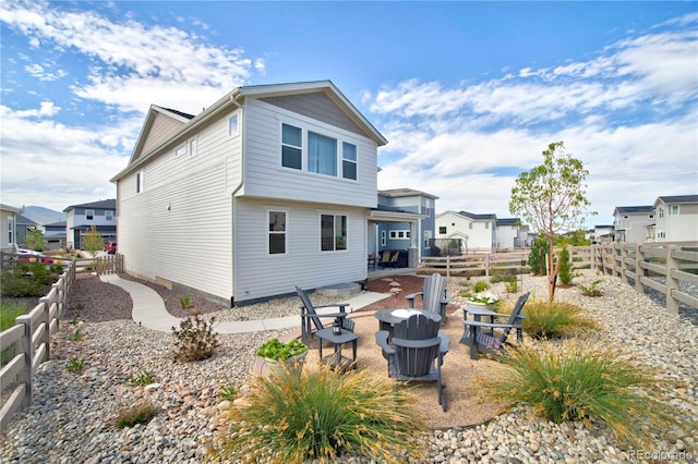 rear view of house with a fire pit