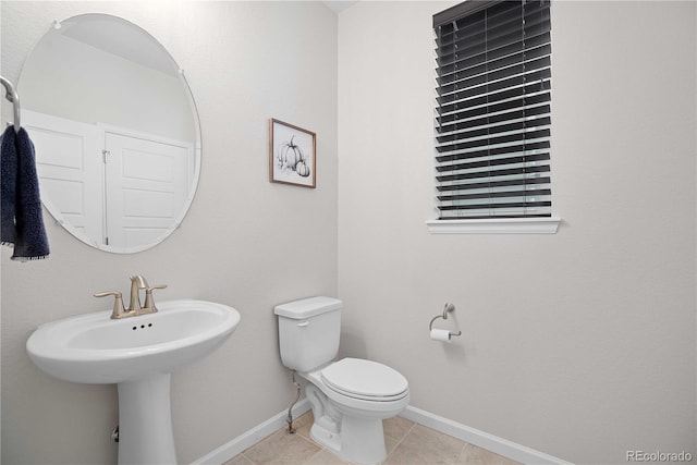 bathroom with toilet and tile patterned floors