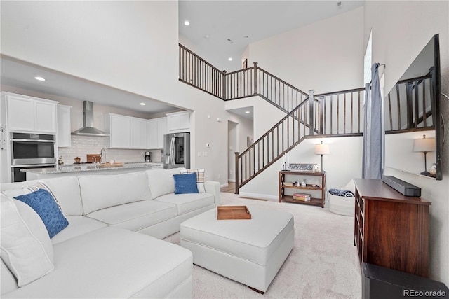 carpeted living room with a high ceiling