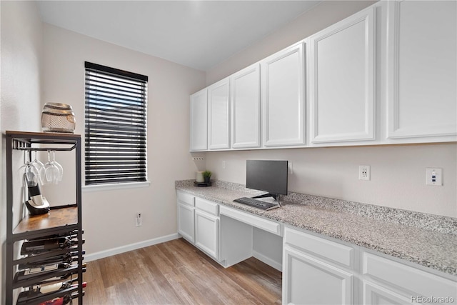 office area featuring built in desk and light hardwood / wood-style flooring