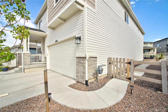 view of side of home featuring a garage