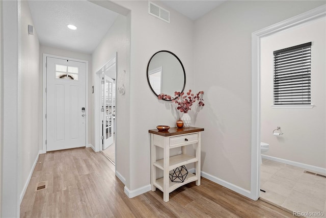 foyer entrance with light hardwood / wood-style floors