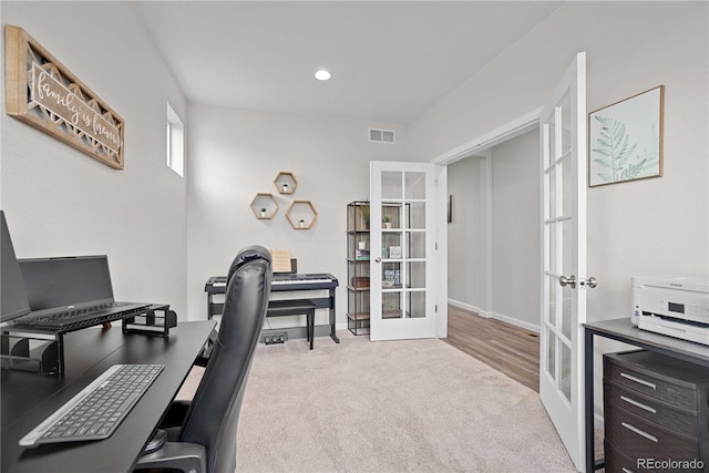 office with french doors and light colored carpet