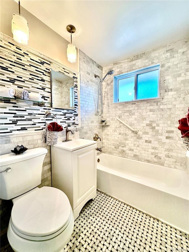 full bathroom featuring tiled shower / bath, tasteful backsplash, toilet, vanity, and tile patterned flooring