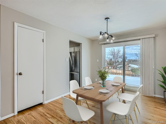 dining room with an inviting chandelier and light hardwood / wood-style floors