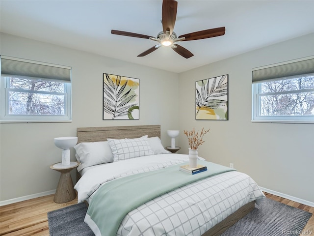 bedroom with light hardwood / wood-style floors and ceiling fan