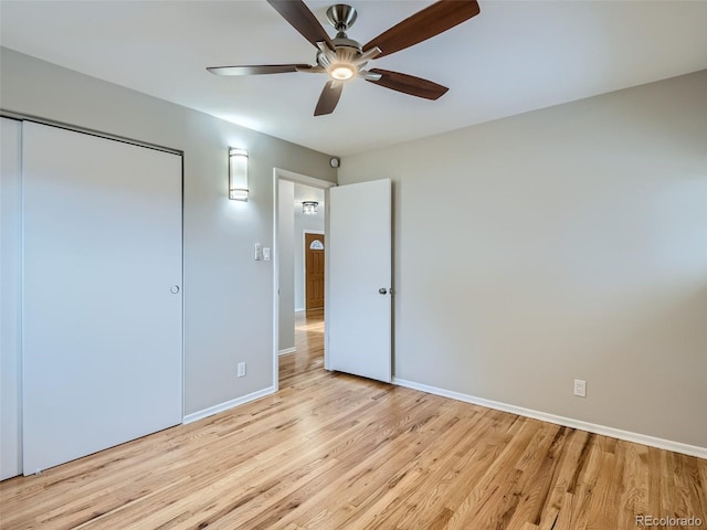 unfurnished bedroom with ceiling fan, light hardwood / wood-style floors, and a closet