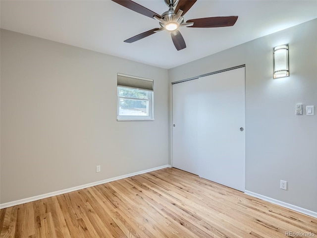 unfurnished bedroom featuring ceiling fan, light wood-type flooring, and a closet