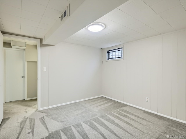 basement featuring light colored carpet