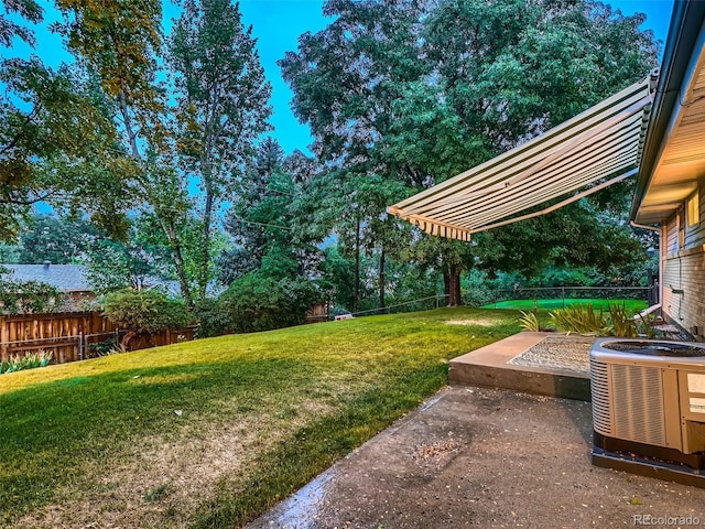 view of yard with cooling unit and a patio