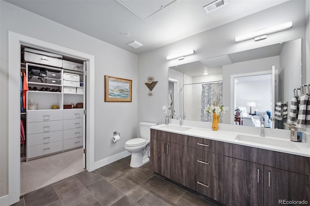 bathroom featuring vanity, a textured ceiling, and toilet