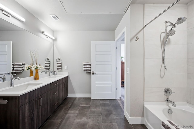 bathroom featuring vanity and tiled shower / bath combo