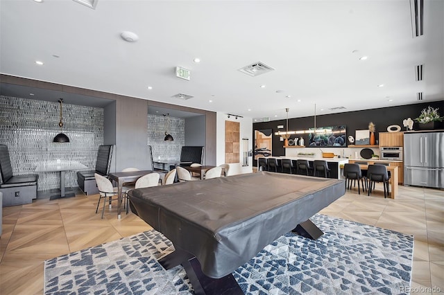 recreation room with light parquet flooring, bar area, and billiards