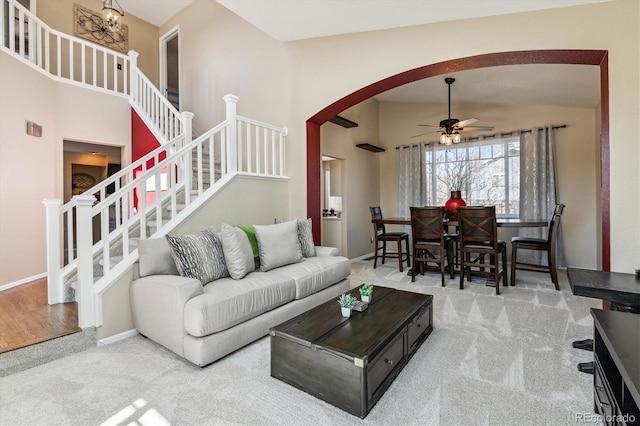 12559 W Crestline Dr, Littleton, CO 80127 - living area with arched walkways, baseboards, a ceiling fan, and carpet