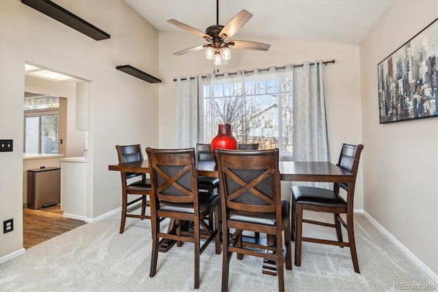 12559 W Crestline Dr, Littleton, CO 80127 - carpeted dining room featuring plenty of natural light, baseboards, vaulted ceiling, and a ceiling fan