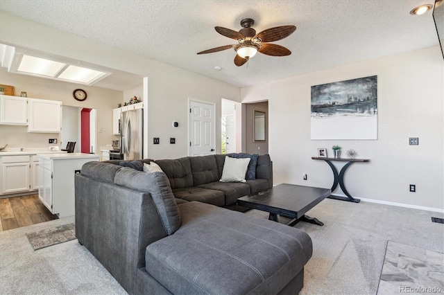 12559 W Crestline Dr, Littleton, CO 80127 - living area featuring a ceiling fan, light colored carpet, and a textured ceiling