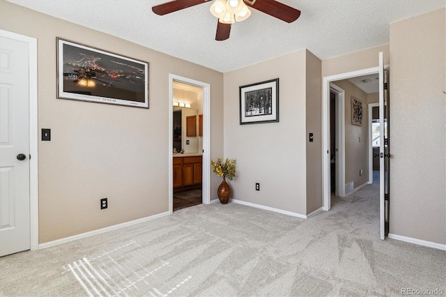 12559 W Crestline Dr, Littleton, CO 80127 - unfurnished bedroom with ensuite bathroom, baseboards, ceiling fan, a textured ceiling, and carpet floors