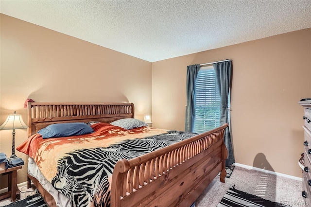 1250 S Monaco Street Parkway Unit 49, Denver, CO 80224 - carpeted bedroom with baseboards and a textured ceiling