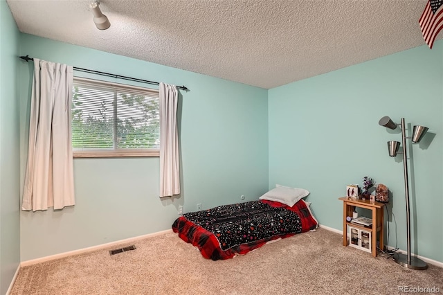 1250 S Monaco Street Parkway Unit 49, Denver, CO 80224 - carpeted bedroom with a textured ceiling