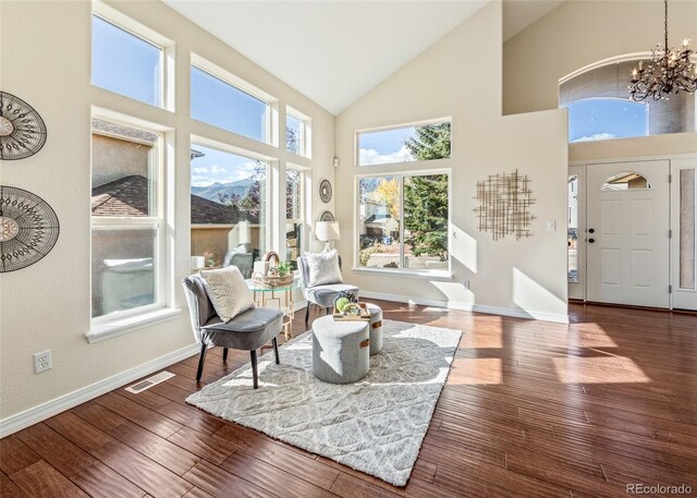 sunroom / solarium with lofted ceiling and an inviting chandelier